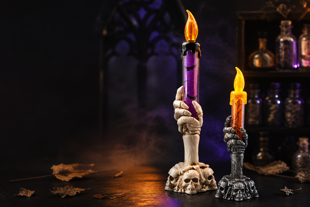 Two skeleton-hand candle lights glowing in a dark apothecary scene with purple mist